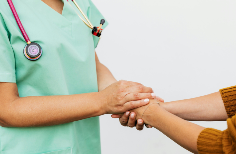 Profissional de home care segurando as mãos de um paciente